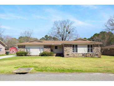 Charming single-story home featuring a brick facade, landscaped yard, and a well-maintained lawn at 166 Westminister Blvd, Goose Creek, SC 29445