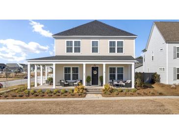 Charming two-story home with a welcoming front porch and manicured landscaping at 201 Symphony Ave, Summerville, SC 29486