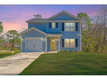 Charming two-story home with light blue siding, a well-manicured lawn, and attached garage at sunset at 3405 Painswick Rd, Johns Island, SC 29455