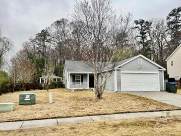 Charming single Gathering home featuring a well-maintained front yard and attached two car garage at 344 Eagle Ridge Rd, Summerville, SC 29485