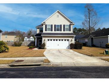 Charming two-story home featuring a two-car garage, landscaped yard, and classic architectural details at 3614 Haymont Ln, Ladson, SC 29456