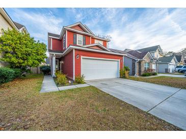 Charming red two-story home with a two car garage and well-maintained lawn at 8849 Kellum Dr, North Charleston, SC 29420