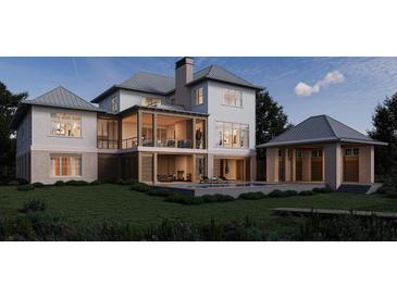 A stunning two-story home exterior featuring a pool, covered porch, and lush landscaping at 925 Fish Camp Rd, Charleston, SC 29492