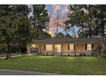 Charming brick home featuring a manicured lawn and inviting front entrance at 113 Harter Dr, Summerville, SC 29485