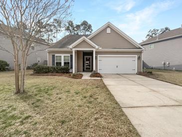 Charming one-story home features a well-maintained lawn and a two-car garage at 139 Gazania Way, Charleston, SC 29414
