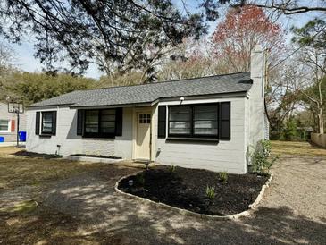 Charming single-story home featuring a well-manicured front yard and neutral color palette at 1563 Traywick Ave, Johns Island, SC 29455