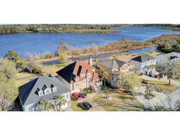 Stunning aerial view of waterfront homes with beautifully landscaped yards along a serene river at 1739 Indigo Island Dr, Hanahan, SC 29410