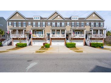 Attractive townhomes feature individual garages and covered front porches, creating inviting curb appeal at 1930 Carolina Towne Ct, Mount Pleasant, SC 29464