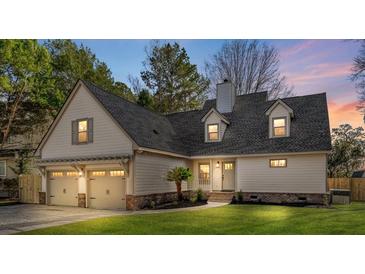 Charming home exterior featuring a two-car garage, manicured lawn, and craftsman-style architectural details at 316 Anadale Ct, North Charleston, SC 29418