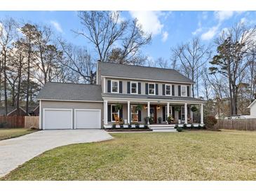 Charming two-story home featuring a welcoming front porch and a spacious two-car garage at 404 Black Oak Blvd, Summerville, SC 29485