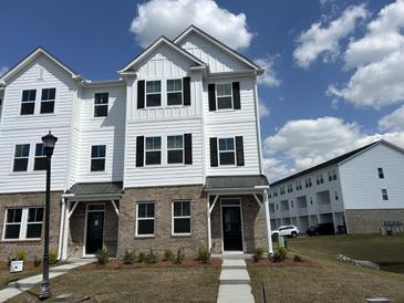 New two-story townhouse featuring black shutters, brick facade and covered front porch at 5126 Double Eagle, Summerville, SC 29485