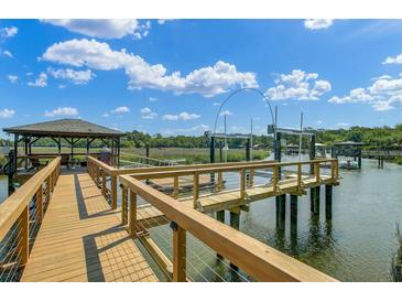 Waterfront property featuring private dock with boat lift and gazebo at 8704 Middleton Point Ln, Edisto Island, SC 29438