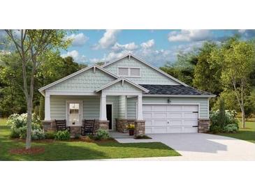 Charming single-story home with stone accents, covered porch, two-car garage, and manicured lawn at 1014 Tulip Shell St, Summerville, SC 29485