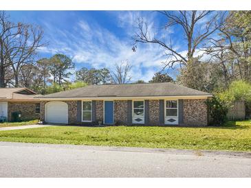 Charming brick home featuring a well-maintained lawn and a bright blue front door at 103 Sprucewood Dr, Summerville, SC 29485