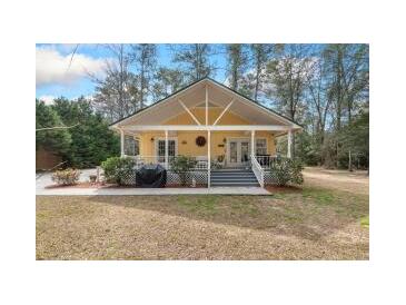 Charming cottage-style home with a welcoming front porch, perfect for relaxing and enjoying the outdoors at 104 Gervais St, Walterboro, SC 29488
