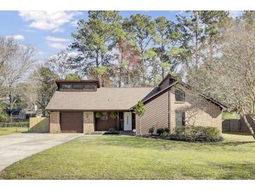 Charming home featuring a brick and wood exterior with a well-manicured lawn and an attached garage at 107 Four Iron Dr, Summerville, SC 29483