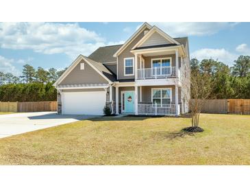 Charming two-story home featuring a welcoming porch, second story balcony, and a well-maintained front yard at 126 Lakelyn Rd, Moncks Corner, SC 29461