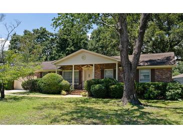 Charming brick home with a covered front porch and mature landscaping creating great curb appeal at 1308 Coleridge St, Charleston, SC 29407