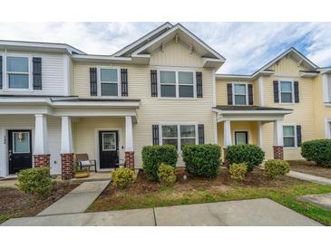 Inviting townhouse with a well-maintained lawn and charming front porch at 138 Hidden Palms Blvd, Summerville, SC 29485