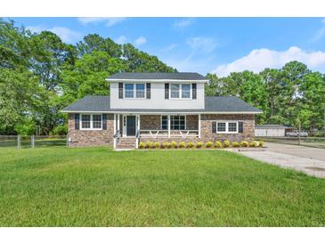Charming brick home with a spacious front yard and inviting curb appeal at 203 Horseshoe Rd, Moncks Corner, SC 29461