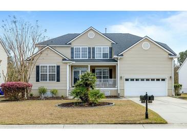 Charming home with a two-car garage, a covered front porch, manicured lawn and a nice garden at 2788 Carolina Isle Dr, Mount Pleasant, SC 29466