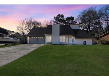 Charming single-story home with a well-maintained lawn and attached two-car garage at 2915 Nantuckett Ave, North Charleston, SC 29420
