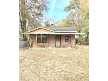 Charming home featuring a covered front porch, ideal for enjoying the outdoors and relaxing with comfortable seating at 313 Springwood Dr, Walterboro, SC 29488