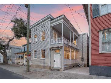 Charming two-story home featuring double porches and quaint architectural details in a historic neighborhood at 40 Pitt St, Charleston, SC 29401