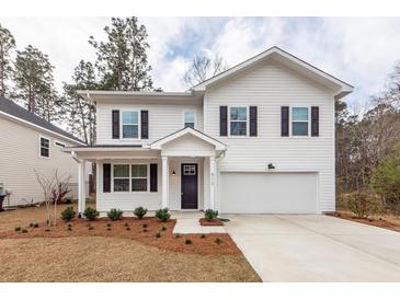 Charming two-story home with white siding, dark shutters, and a well-manicured lawn at 413 Renau Blvd, Summerville, SC 29483