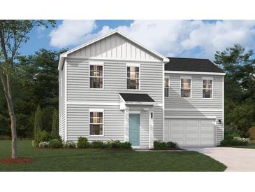 Charming two-story home with light gray siding, well-manicured lawn and attached two-car garage at 4159 Rising Tide Dr, Summerville, SC 29485