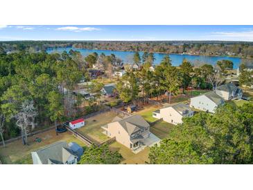 Picturesque aerial view of a lakeside community, showcasing lush greenery and waterfront homes at 1633 Pimlico Blvd, Moncks Corner, SC 29461