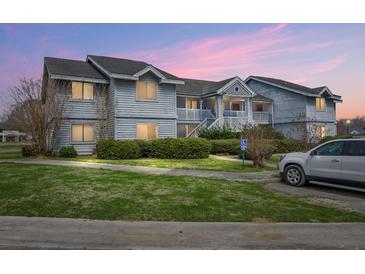 Charming two-story condominium with lawn, shrubbery, and designated handicap parking space at 2608 Hidden Cove Dr, Moncks Corner, SC 29461