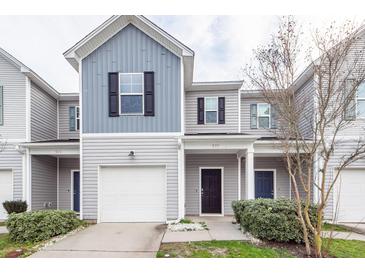 Charming townhome featuring a gray facade, well-maintained landscaping, and an attached one-car garage at 522 Truman Dr, Goose Creek, SC 29445