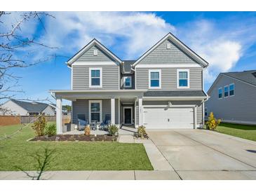 Charming two-story home with gray siding, a covered front porch, and a well-maintained lawn at 107 Cotton Blossom Way, Summerville, SC 29485