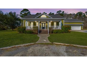 Charming home with a covered front porch, manicured lawn, and inviting entrance with stairs at 2101 Heavens Way, Summerville, SC 29483