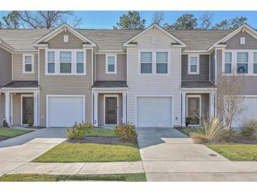 Charming townhomes with garages and well-maintained lawns offer curb appeal and convenient parking at 4678 Palm View Cir, North Charleston, SC 29418
