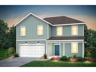 Charming two-story home with blue siding, a garage, a covered porch, and lush landscaping at 746 Meadowbrook Lane, Summerville, SC 29486