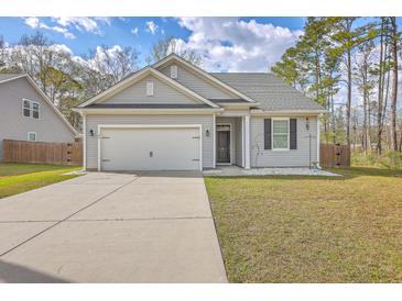 Charming single-story home with gray siding, manicured lawn, and attached two-car garage at 94 Dean Dr, Summerville, SC 29483