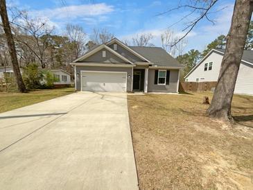 Charming single Gathering home with a two-car garage and a well-maintained lawn and driveway at 96 Dean Dr, Summerville, SC 29483
