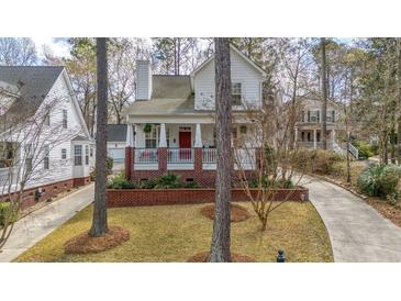 Charming home featuring a brick foundation, inviting front porch and well-manicured lawn at 109 White Pine Way, Summerville, SC 29485