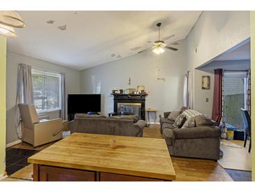 Inviting living room with a fireplace, neutral paint, comfortable seating, and natural light at 114 Tennyson Way, Summerville, SC 29486