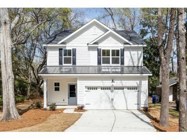 Charming two-story home showcasing black shutters and a spacious two-car garage at 1630 Balsam St, Charleston, SC 29407