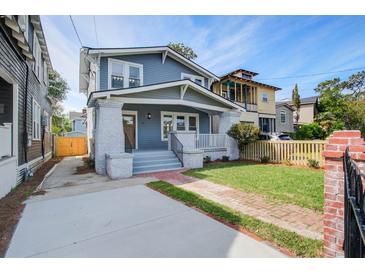 Charming two-story home with brick walkway, fresh lawn and inviting covered front porch at 35 Cypress St, Charleston, SC 29403