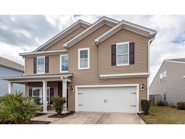 Charming two-story home featuring a spacious two-car garage and classic exterior details at 613 Zinnia Dr, Goose Creek, SC 29445