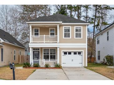 Charming two-story home with a double balcony and a well-manicured lawn at 120 Diploma Dr, Ladson, SC 29456