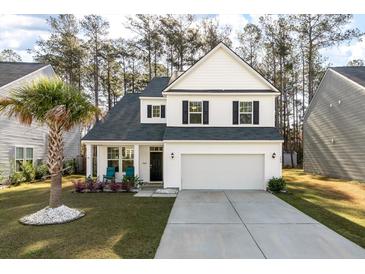 Charming two-story home features a well-manicured lawn, a two-car garage, and lovely landscaping at 133 Caleb Ct, Ladson, SC 29456