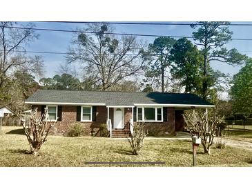 Charming brick ranch home featuring a well-manicured lawn and a cozy covered entrance at 161 Palm St, Walterboro, SC 29488