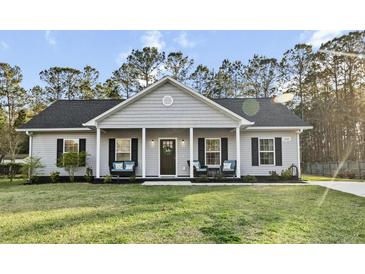 Charming single story home with a covered front porch and well maintained lawn and landscaping at 218 Mohican Cir, Summerville, SC 29483