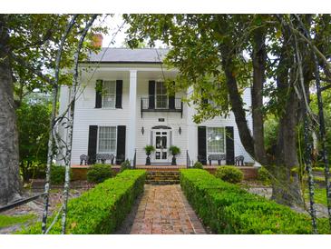 Stunning two-story home with brick path, manicured hedges, and lush green landscaping at 219 Rigby St, Reevesville, SC 29471