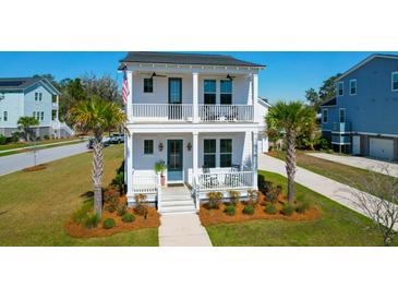 Charming two-story home with double porches, palm trees, and manicured landscaping at 2461 Lieutenant Dozier Dr, Johns Island, SC 29455